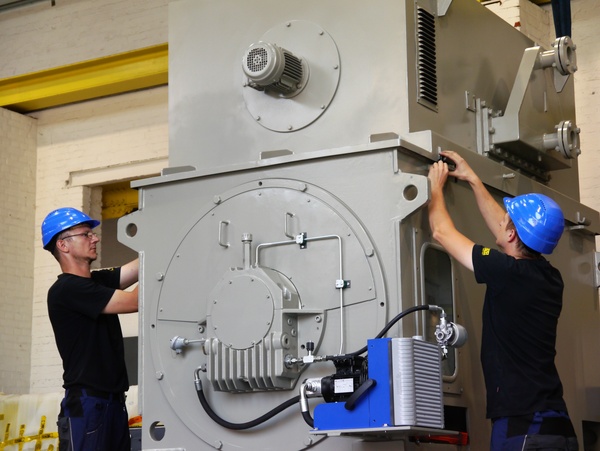 Electronics technicians mounting a 3000V motor for reciprocating compressor Electronics technicians mounting a 3000V motor for reciprocating compressor