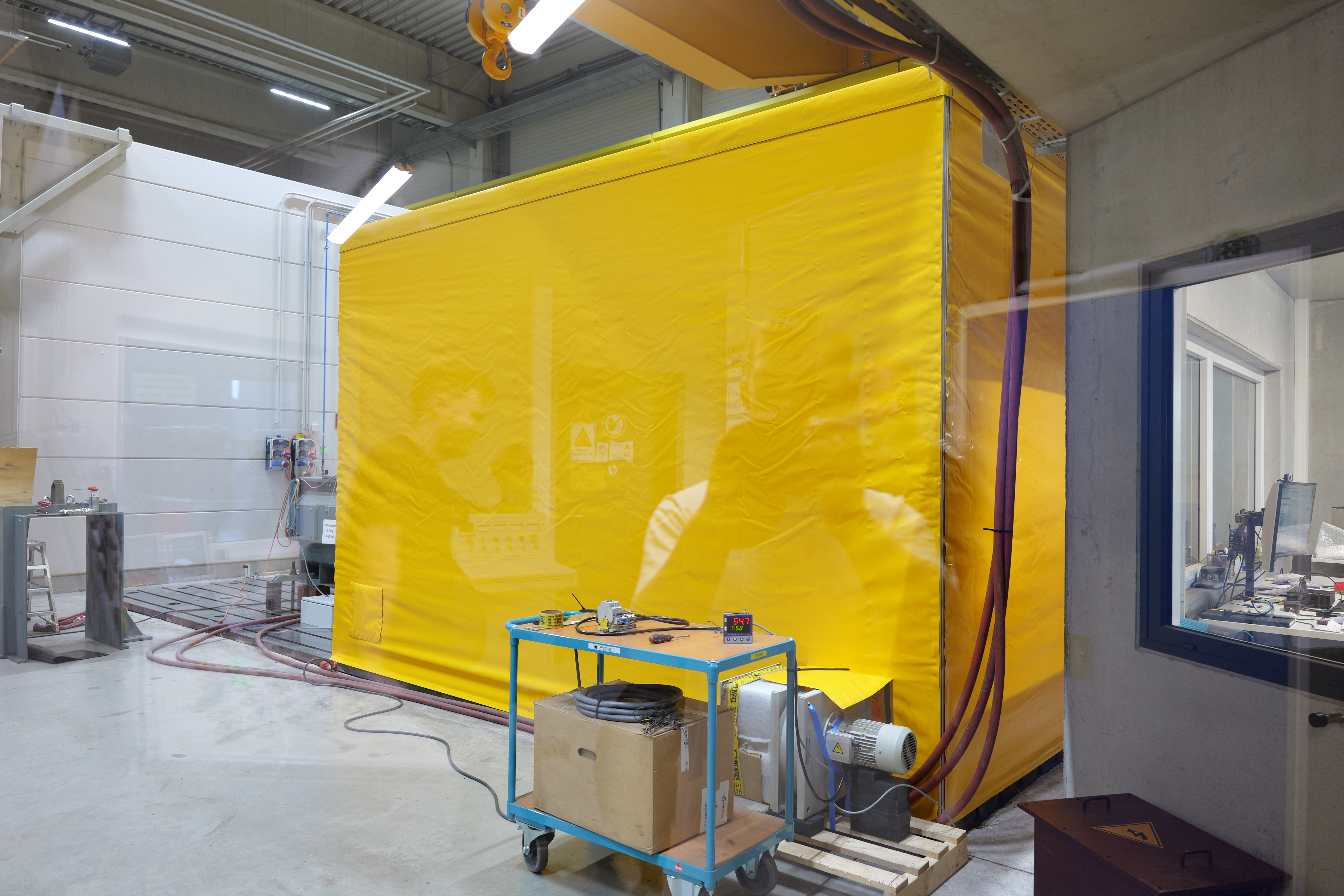 Engineer monitoring high voltage motor in thermal tent