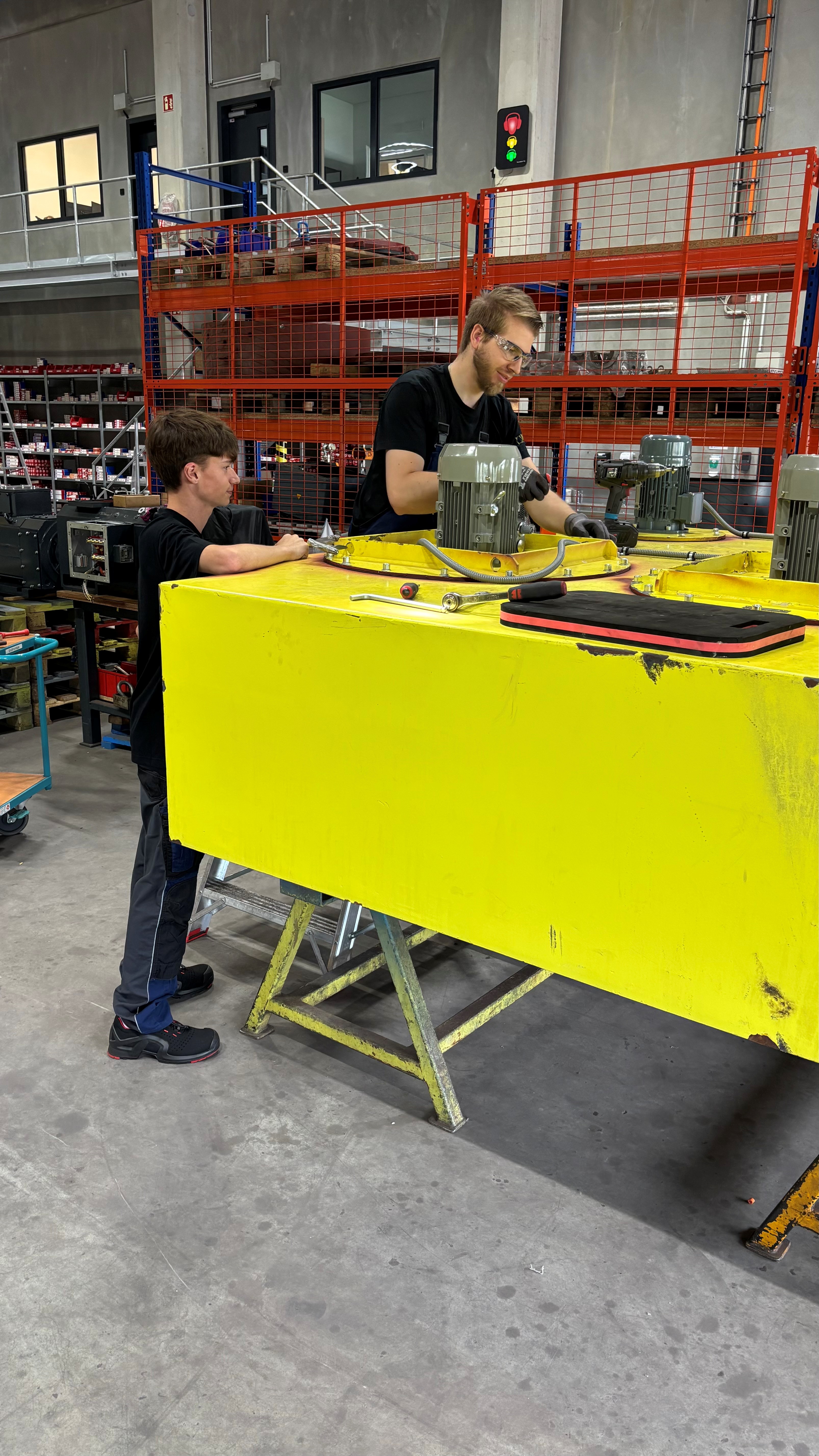 Apprentice gaining hands-on experience in motor production during vocational training