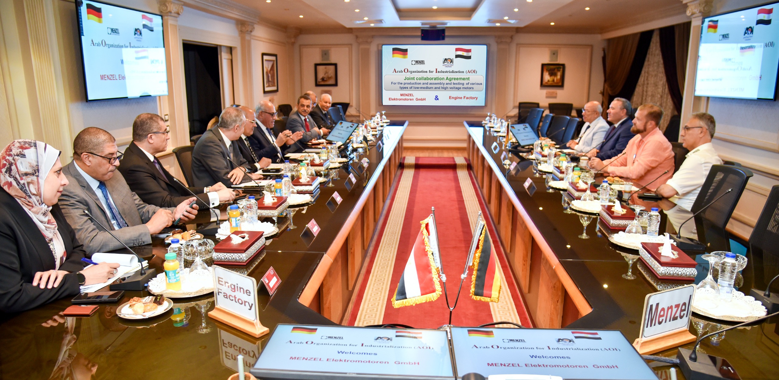 Menzel at the signing of the cooperation agreement with AOI